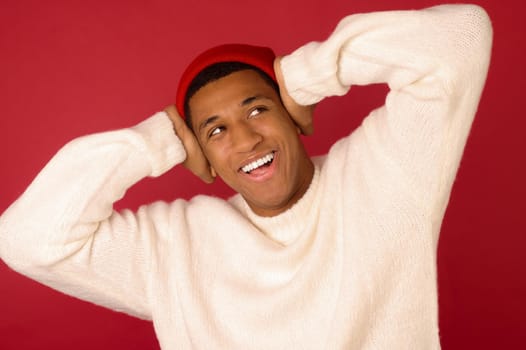 Good mood. Young dark-skinned man in santa hat smiling