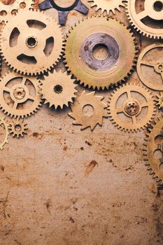 Steampunk background from mechanical clocks details over old metal background. Inside the clock, gears