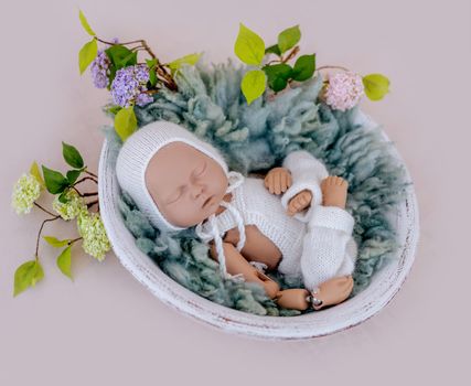 Doll mannequin of newborn baby for photographer practice. Concept of infant cute photosession