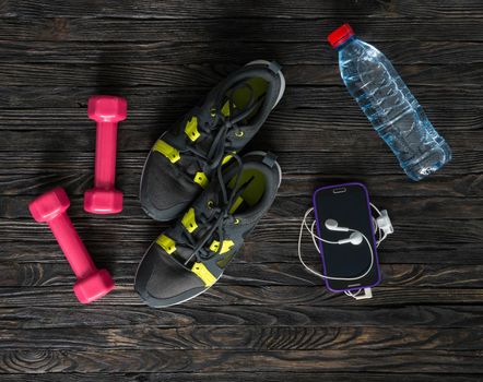 sport fitness items on dark wooden background with empty text space