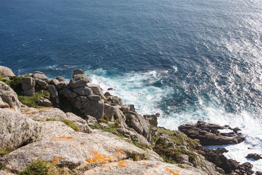 Beautiful landscape scenery of Cape Finisterre - View from Fisterra in Spain. Mountain ocean shore. Sea waves crash of rocky beach