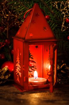 Red christmas candlestick over holiday decorations on the table