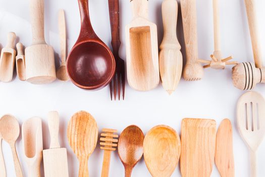 Assortment of wooden kitchen utensils on a white background