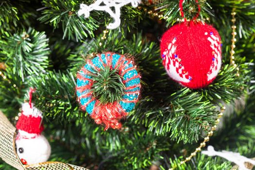 Knitted christmas toys on the christmas tree