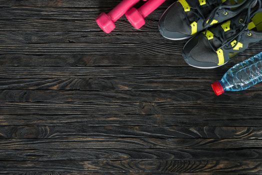 sport fitness items on dark wooden background with empty text space