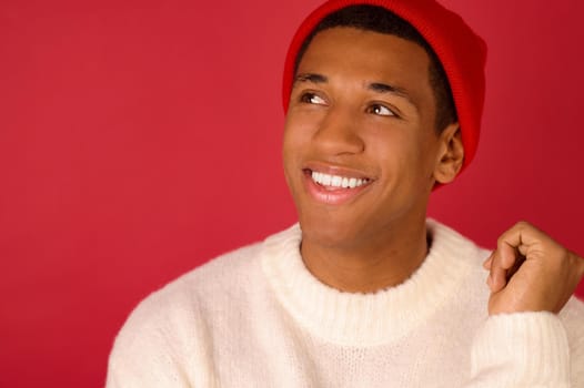 Good mood. Young dark-skinned man in santa hat smiling