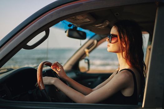 pretty woman in sunglasses driving a car trip. High quality photo