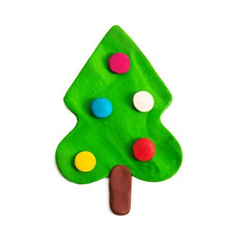 decorated green new year tree figure made of plasticine isolated on white background