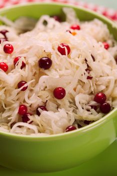 sauerkraut with cranberry in a green bowl