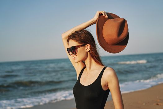 woman in a hat sunglasses by the ocean travel sun. High quality photo