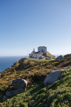 Beautiful landscape scenery of lighthouse at Cape Finisterre - View from Fisterra in Spain. Mountain ocean shore