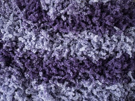 knitted pattern of thick woolen violet thread. abstract background