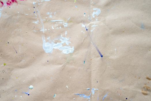 Abstract drawing of strokes and droplets at watercolor paper