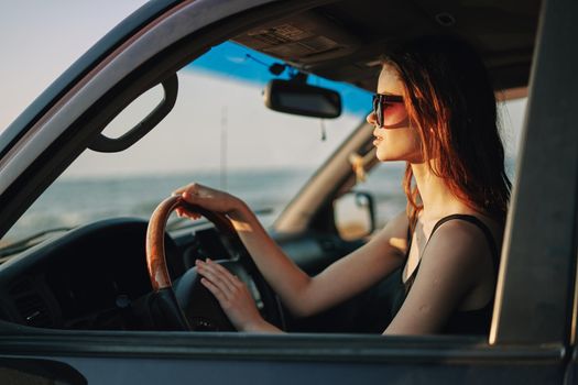 pretty woman in sunglasses driving a car trip. High quality photo