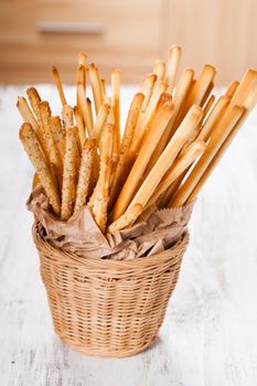 Different types of grissini breadsticks in a basket