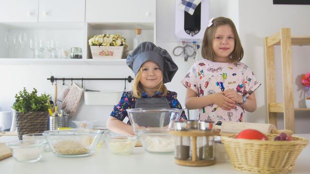 Portrait of two girls on the kitchen before cooking. close up