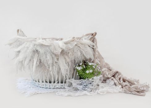 Cute newborn digital background for infant baby photosession. Wicker basket with knitted fabric and fur decorated plants