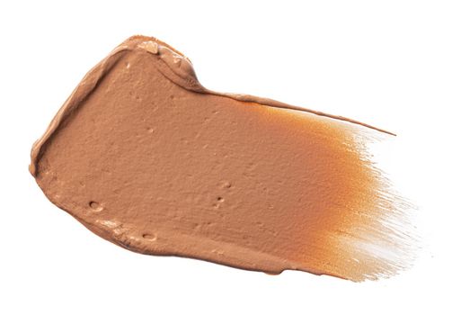 Smudged stain of a cream foundation isolated on white, close up