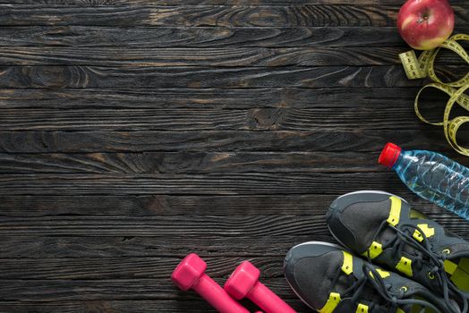 sport fitness items on dark wooden background with empty text space