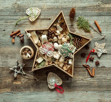 christmas decorations in a star shaped box on wooden background
