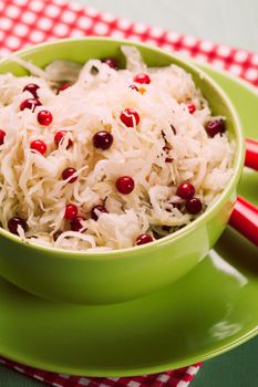 sauerkraut with cranberry in a green bowl