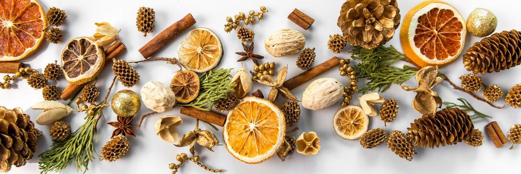 christmas decorations horizontal background with space for text of dried oranges, cinnamon and cones. white background