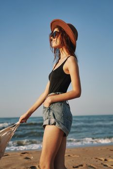 woman in trendy summer clothes by the ocean vacation sun. High quality photo