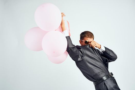business man in a suit sunglasses office balloons. High quality photo