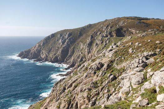 Beautiful landscape scenery of Cape Finisterre - View from Fisterra in Spain. Mountain ocean shore. Sea waves crash of rocky beach