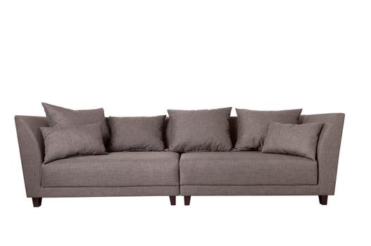 Modern grey fabric sofa with pillows isolated on white background. Front view. Strict style furniture