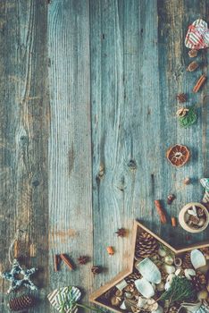 christmas decorations in star shaped box on old wooden background with text space top view