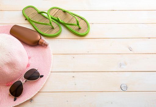 beach accessories on a white wooden background