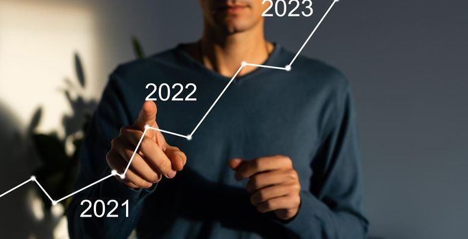 businessman hand working with virtual chart business on touch screen computer as concept.