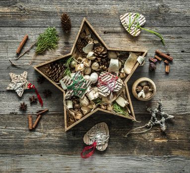christmas decorations in a star shaped box on wooden background