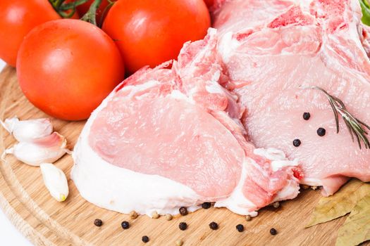 Raw loin slices on the board isolated on white