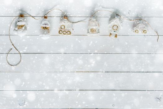 white wooden planks under snow and christmas decorations with text space top view