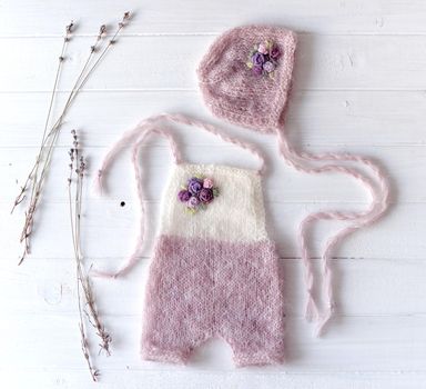 Simple knitted handmade clothes for newborn babies. topview props for photo sessions