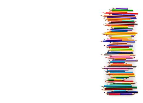 Top view of bright color pencils placed in a row isolated on white background