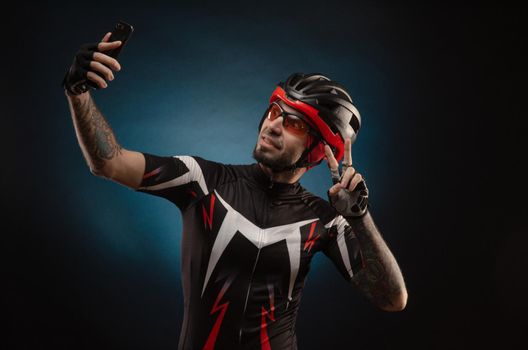 guy is a cyclist in a Bicycle helmet takes a selfie