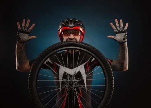 guy-cyclist in a Bicycle helmet with a Bicycle wheel