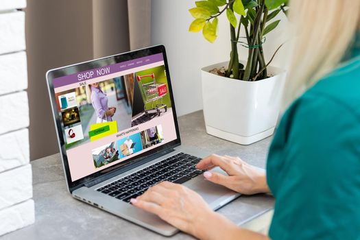 Woman shopping online using her laptop at home.