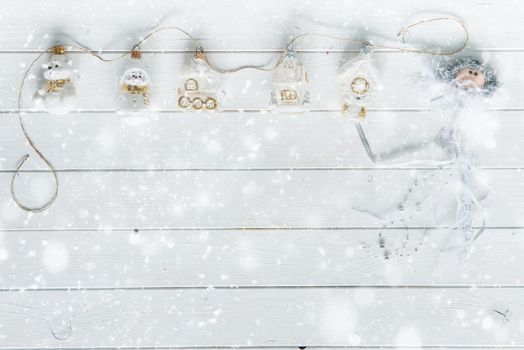 white wooden planks under snow and christmas decorations with text space top view