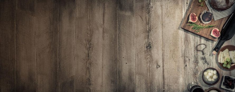 cheeses and brown bread on wooden table with text space