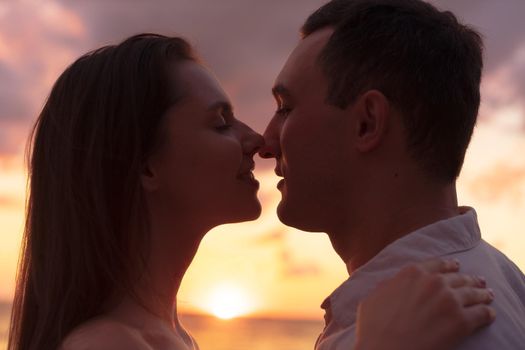 Romantic sensual young couple in love at the sunset, close up