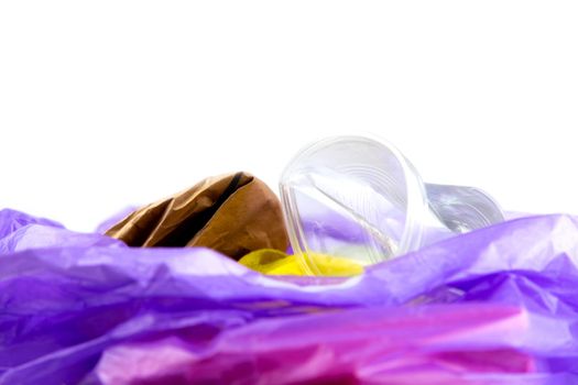 Concept of garbage and pollution. A pile of trash, crumpled plastic cup, packages, paper isolate on a white background.