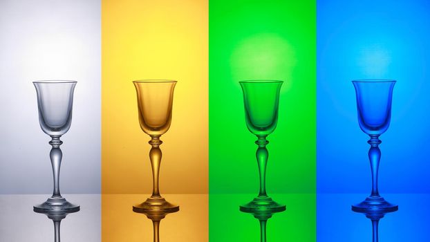 Empty wine glass on a white yellow green blue striped baground
