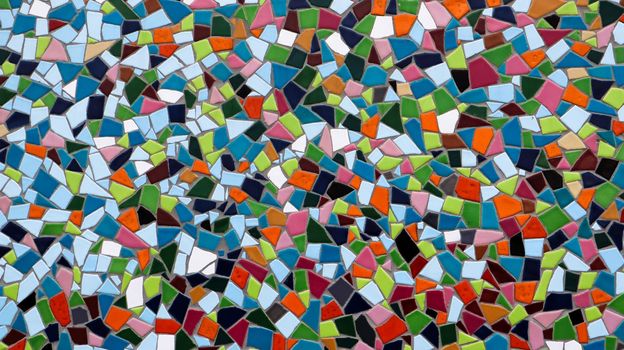 Mosaic on the big wall of different shapes and colors. Abstract colorful mosaic texture background.