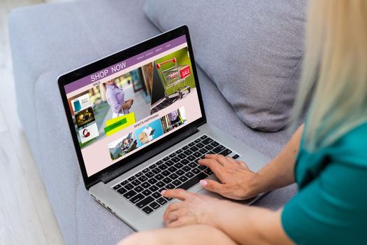 Woman shopping online using her laptop at home.