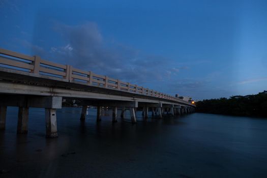 Night sky over bridge over Hickory Pass leading to the ocean in Bonita Springs, Florida.