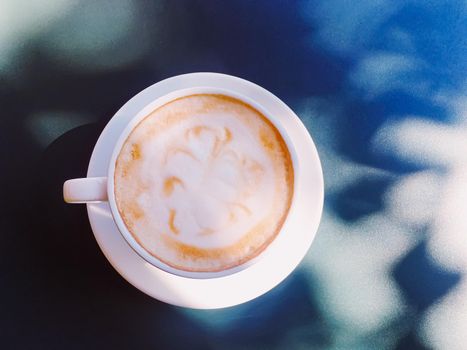 Cappuccino in summer cafe outdoors.